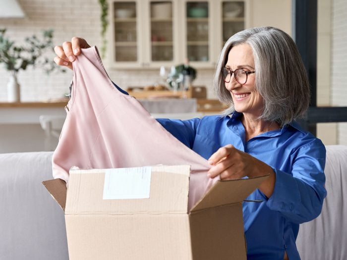 Woman Packing Clothes Away