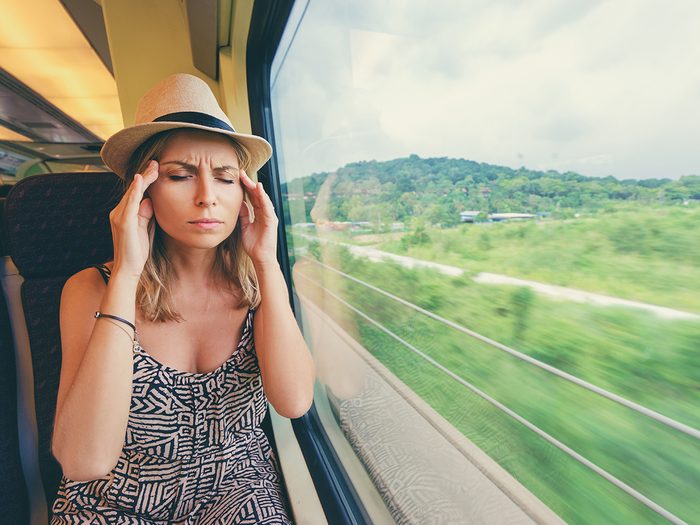 Woman with motion sickness on train