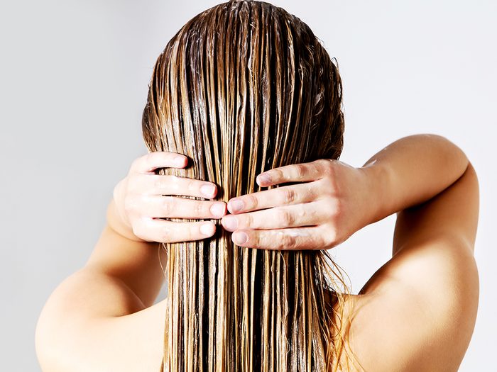 Woman conditioning wet hair