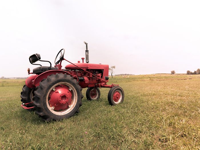 Old farm tractor in field