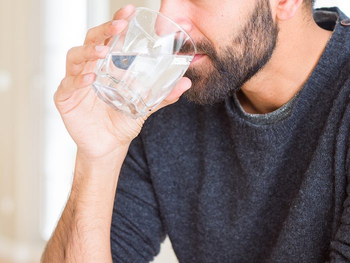 Symptoms of diabetes - thirsty man drinking water