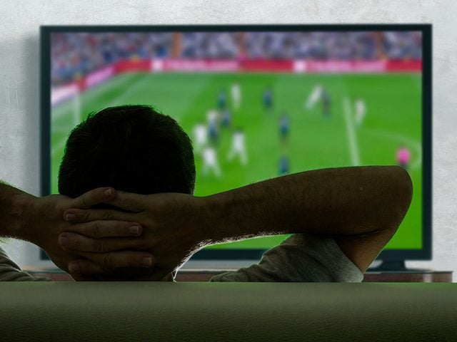 Man watching big screen TV