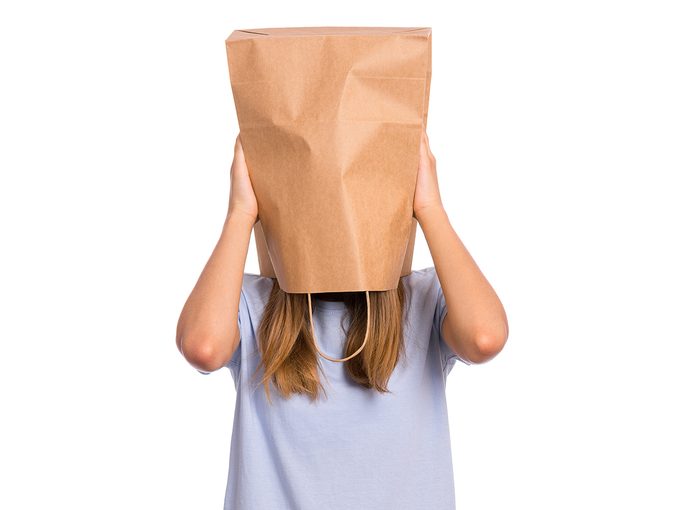 Girl with paper bag on head