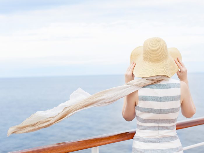 Woman on windy cruise ship deck