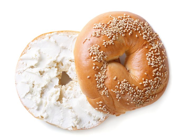 Halved bagel with cream cheese