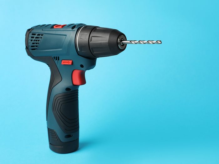 Power drill against blue background