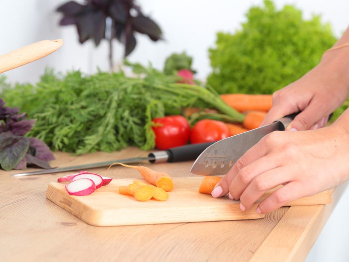 Slicing vegetables on cutting board