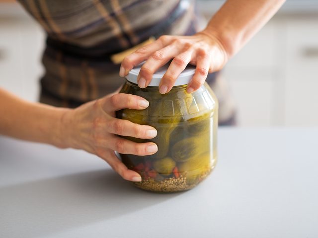 Woman can't open jar of pickles
