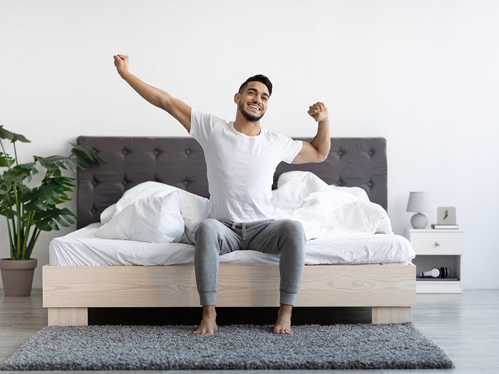 Healthy sleep habits - Man waking up happy