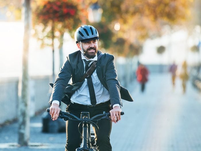 Man on bicycle wearing bike helmet