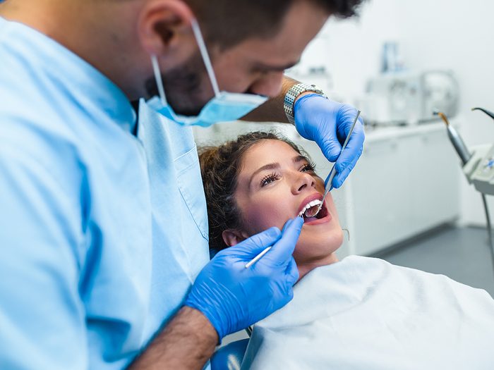 Signs of oral cancer - dentist working on patient