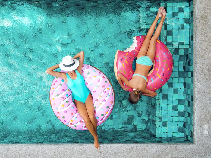 Women floating in resort pool