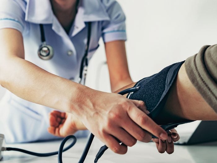 Nurse checking patient's blood pressure