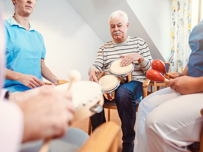 Benefits of music therapy - Elderly person playing drums 