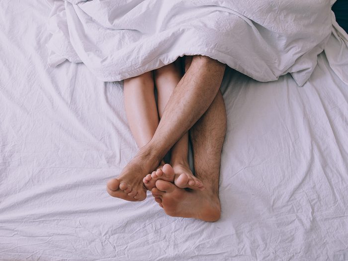 Feet in bed - sex concept
