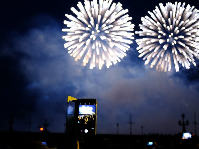 Fireworks and person holding phone