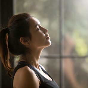Indoor Air Quality - Woman standing in front of window