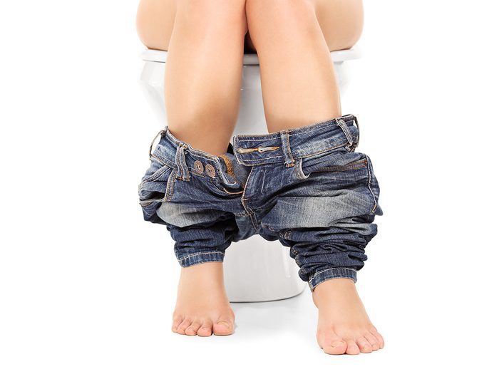 Stress poop - woman on toilet