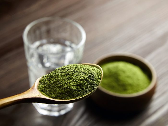 Are Green Powders A Waste Of Money? Feature Image - spoon with green powder and glass of water
