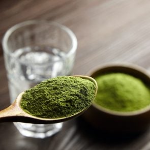 Are Green Powders A Waste Of Money? Feature Image - spoon with green powder and glass of water