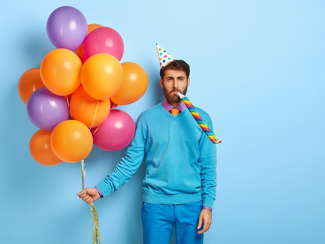 Man at birthday party with balloons