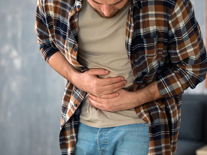 Man with unhealthy gut - stomach cramps