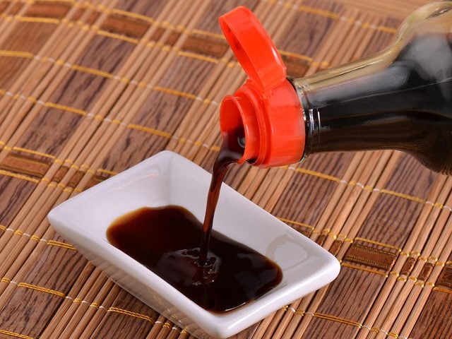 Pouring soy sauce into small bowl