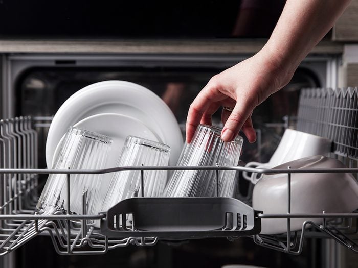 Taking clean dishes out of dishwasher