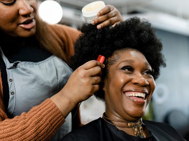 Woman getting hair done at salon