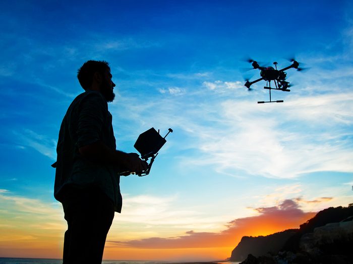 Canada Drone Laws - Silhouette of person flying a drone