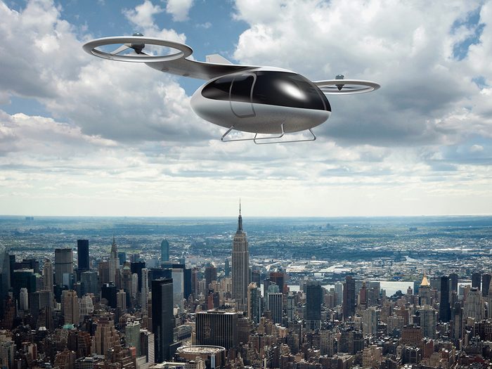 Rendering of a passenger drone flying over cityscape