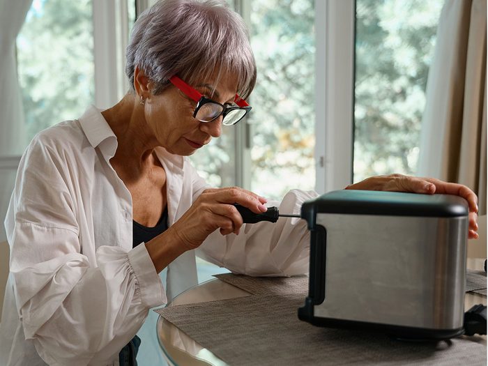 Fix it - Woman repairing toaster