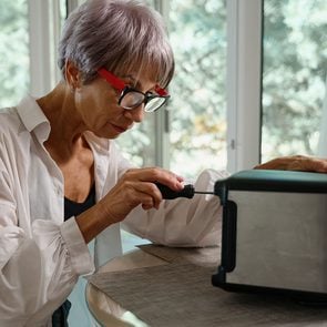 Fix it - Woman repairing toaster