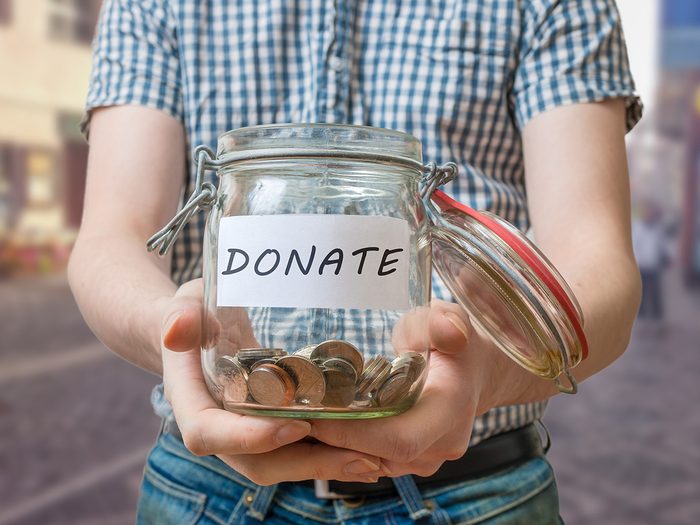Charity - Person holding donation jar