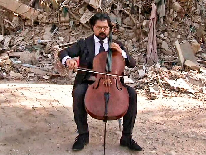 Karim Wasfi plays cello at the site of a car bombing